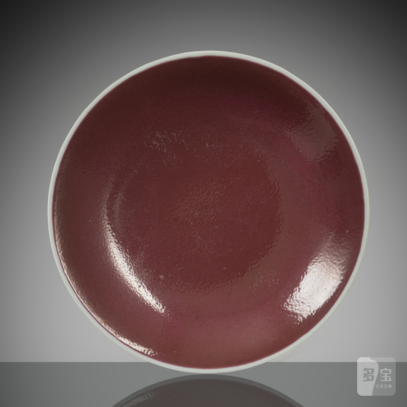 A porcelain plate with a cyclamen-coloured glaze